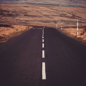 Empty road amidst land