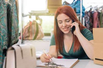 Young woman using mobile phone at home