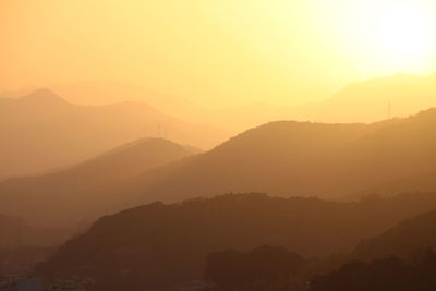 Scenic view of mountains against sky at sunset