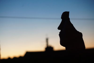 Silhouette woman standing against clear sky