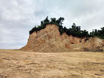 Scenic view of rocks on field against sky