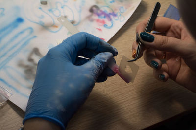 Close-up of person working at workshop