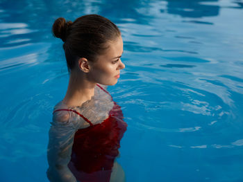 Woman looking away at swimming pool