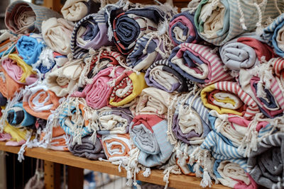 Multi colored towels stacked on shelf