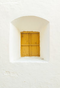 Yellow door of white building