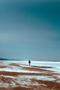 Man on beach against sky