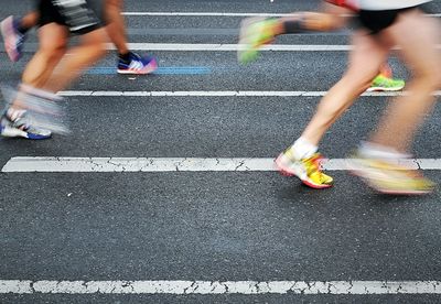 Low section of people running in marathon