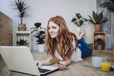 Young woman using mobile phone at home