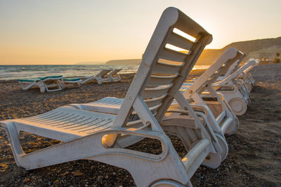 White sunbeds in a sandy beach at sunset. summer vacation concept. cyprus island