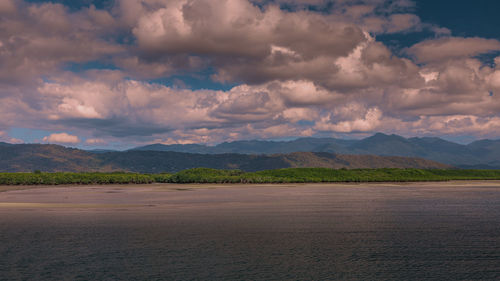 Scenic view of land and mountains against sky