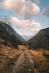 Scenic view of road amidst mountains against sky