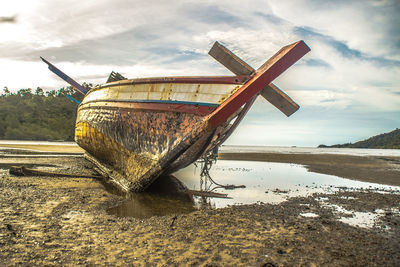 Abandoned boat on shore