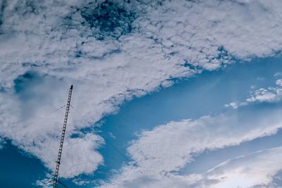Low angle view of communications tower against blue sky