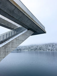 Low angle view of bridge against cloudy sky