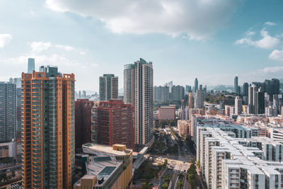 Aerial view of modern buildings in city against sky