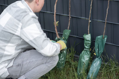 Midsection of man holding plant