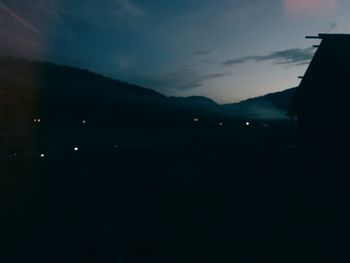 Silhouette buildings against sky at night