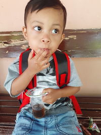 Portrait of cute boy drinking glass