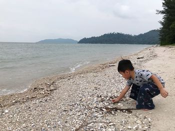 Rear view of boy on beach