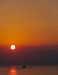 Scenic view of sea against romantic sky at sunset