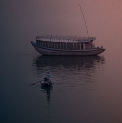 Boat sailing in sea against sky