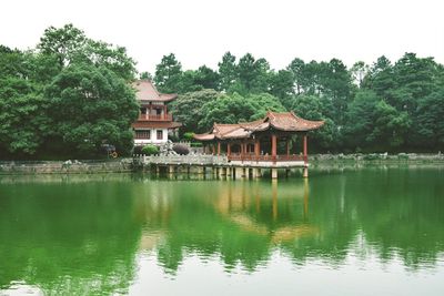 Gazebo by lake against clear sky