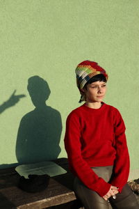 Portrait of boy standing against wall
