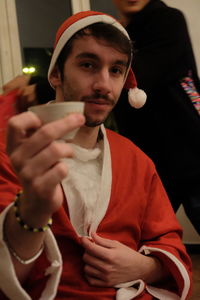 Portrait of young man holding smart phone