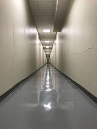 Empty corridor in illuminated building