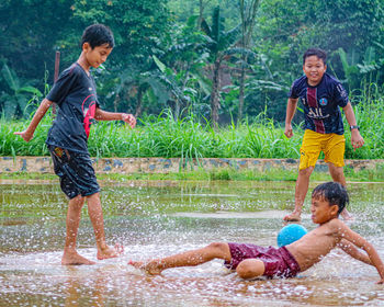 Side view of boy playing in water