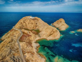 Aerial view on a lighthouse located on a tiny peninsula.