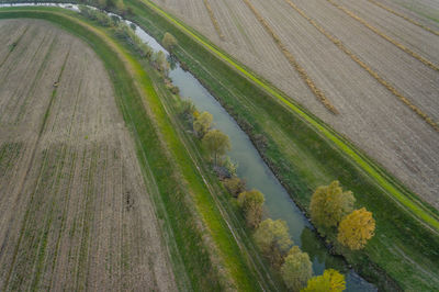 High angle view of canal amidst agricultural field