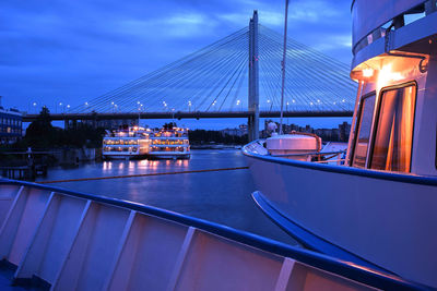 Bridge over river against sky in city