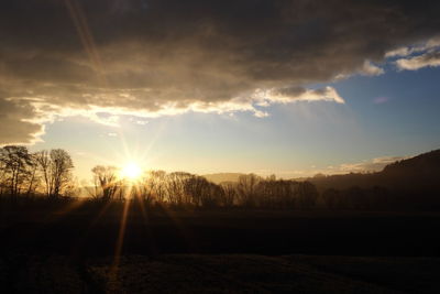 Scenic view of sunset over field