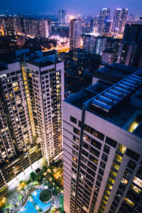 Aerial view of illuminated buildings in city at night