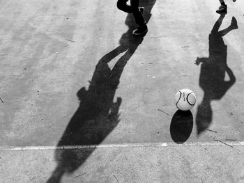 Low section of boys playing soccer at court