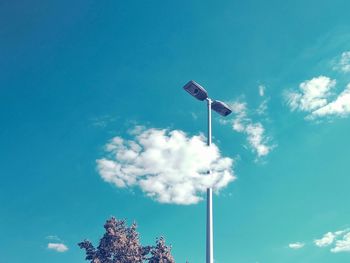 Low angle view of flag against blue sky