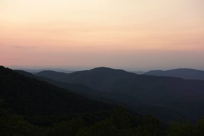 Scenic view of silhouette mountains against sky during sunset