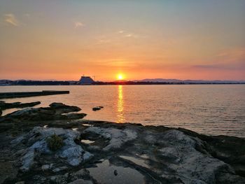 Scenic view of sea against sky at sunset