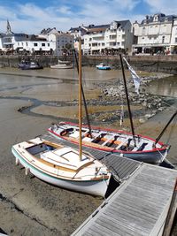 High angle view of boats moored at harbor in city