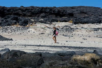 Full length of man walking on rocks