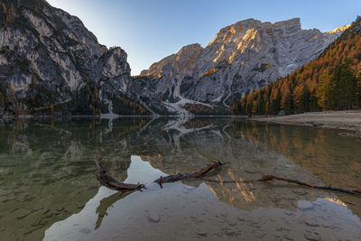 Reflection of mountain in lake at lago di braies in dolomites mountains 