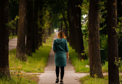 Rear view of woman walking in forest