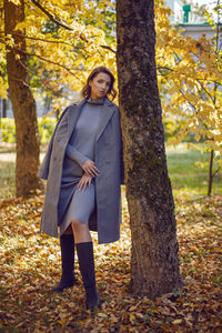 Portrait of young woman standing in forest