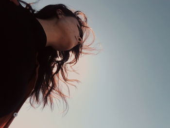 Low angle view of woman against sky