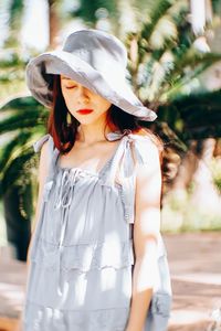 Woman wearing hat while standing outdoors