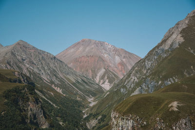 Scenic view of mountains against clear blue sky