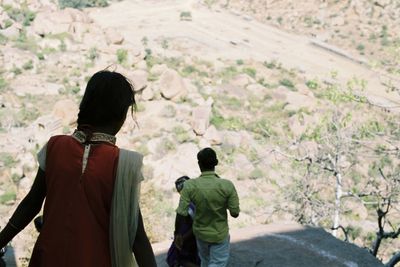 Rear view of people moving down on mountain