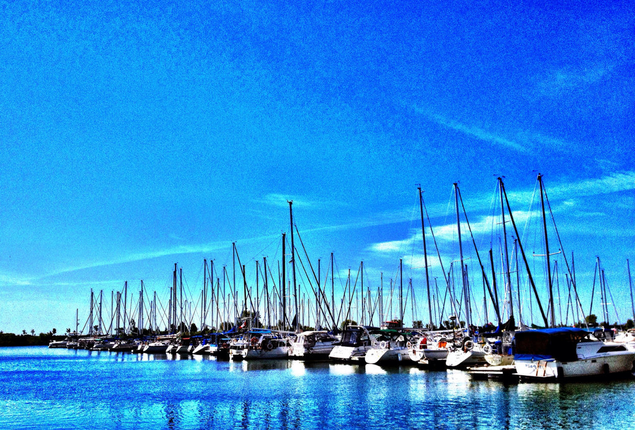 nautical vessel, water, blue, moored, boat, transportation, waterfront, mode of transport, harbor, mast, sailboat, reflection, sky, sea, nature, tranquility, tranquil scene, marina, lake, outdoors