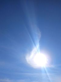 Low angle view of bright sun in sky